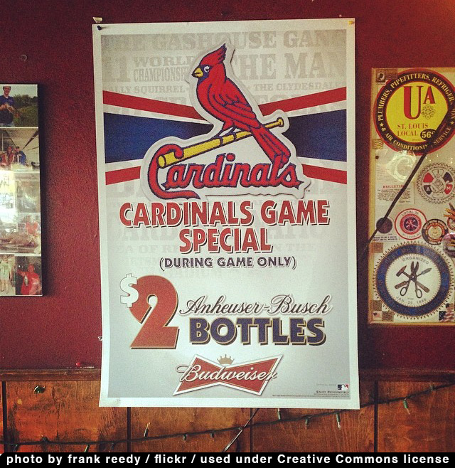 a poster branded with the logo of the St. Louis Cardinals baseball team advertising a 2 bottle of Budweiser for 2 dollars special