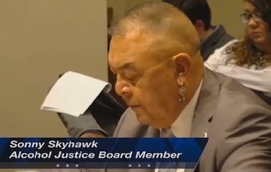 screencap of a tv broadcast showing Sonny Skyhawk testifying