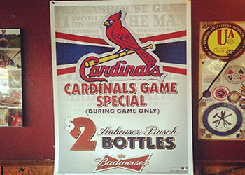 A banner for a budwieser special offer $2 bottles only during games by the St. Louis Cardinals baseball team