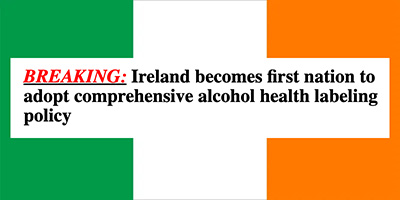 a flag of green, white, and orange vertical stripes (the Irish flag), on top of which is written "breaking: Ireland becomes first nation to adopt comprehensive alcohol health labeling policy"