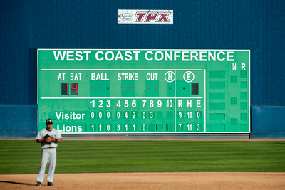 A scoreboard in a small baseball stadium, in front of which stands a fielder, ready to fight alcohol deregulation