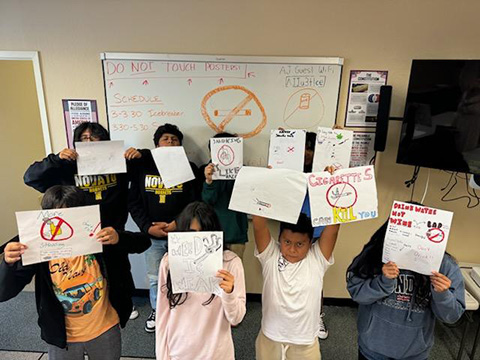 Alcohol Justice Youth holding up hand made signs