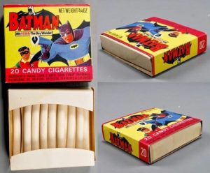 A series of photos of a rectangular box with cartoons of the old, grey-and-navy-costumed Batman on it. They are toy cigarettes, a real product that helped induce kids to smoke.