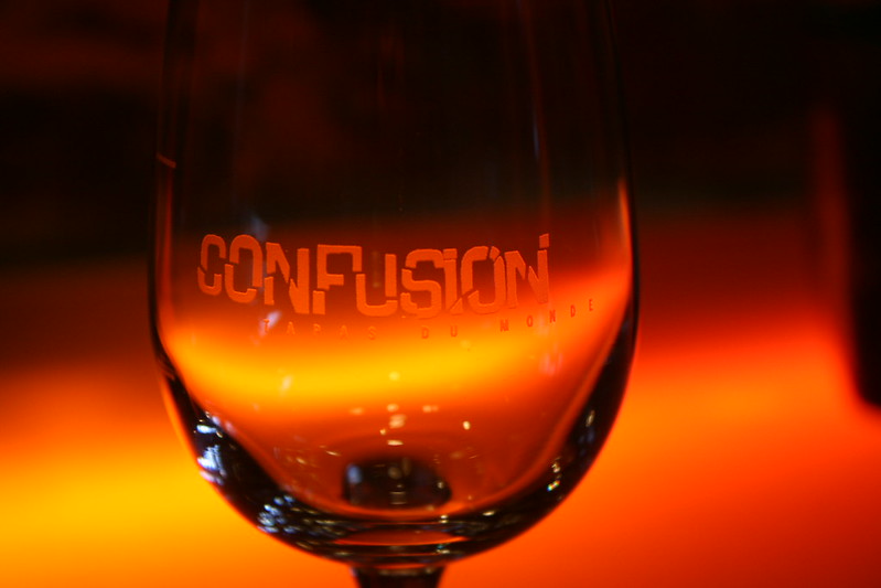 Against a glowing background, a cup with "confusion" etched into it in broken block letters sits.